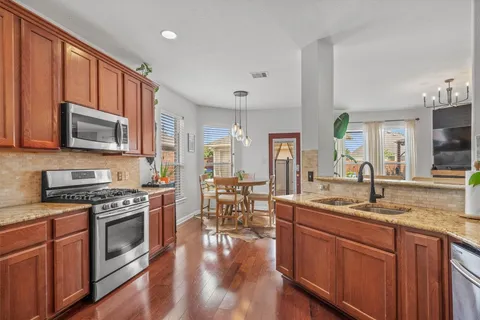 a kitchen with a stove a sink and a microwave
