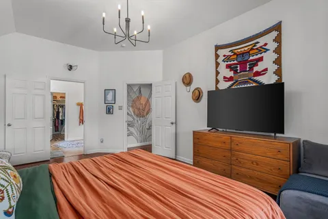 a bedroom with a bed and a flat screen tv