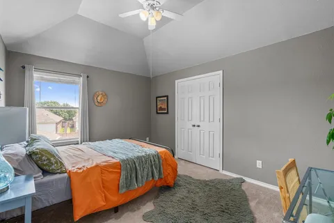 a bedroom with a bed and chandelier