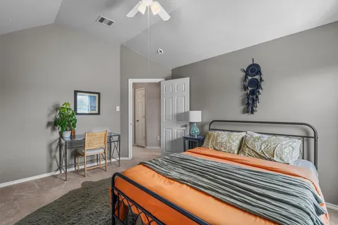 a bedroom with bed and a potted plant