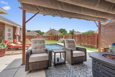 a balcony with furniture and a floor to ceiling window