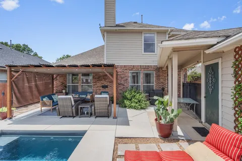 a view of a patio with couches table and chairs and potted plants