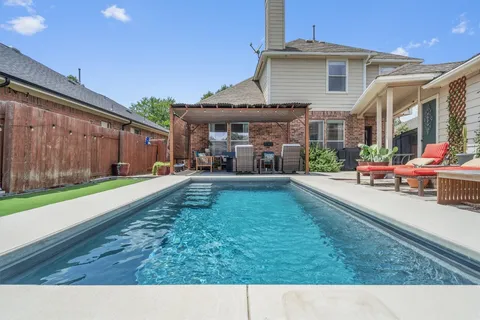 a backyard of a house with yard and outdoor seating