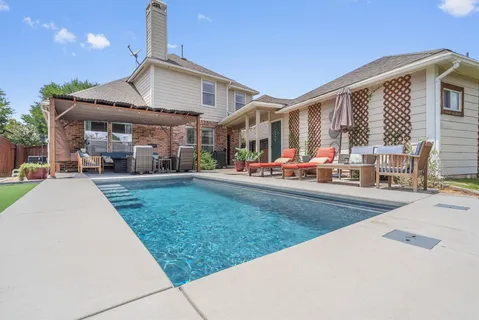 a front view of a house with a yard table and chairs