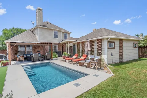 a view of a house with backyard sitting area and porch