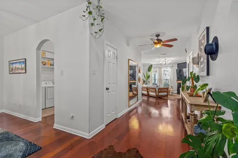 a view of a livingroom with furniture wooden floor and windows