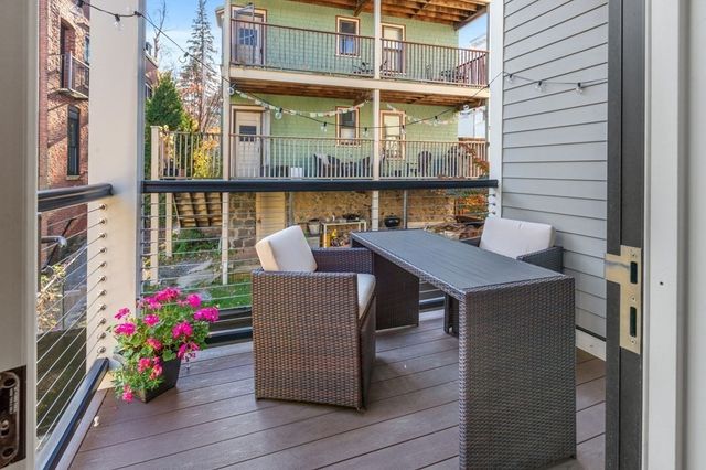 a balcony view with a seating space