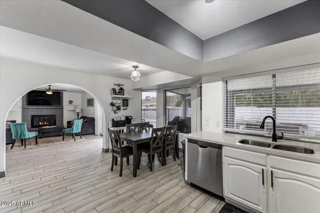 a view of a dining room with furniture and chandelier