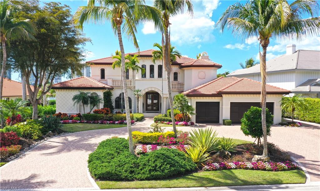 361 Pirates Bight Naples, FL 34103 - Photo 2 of 45 a front view of a house with garden