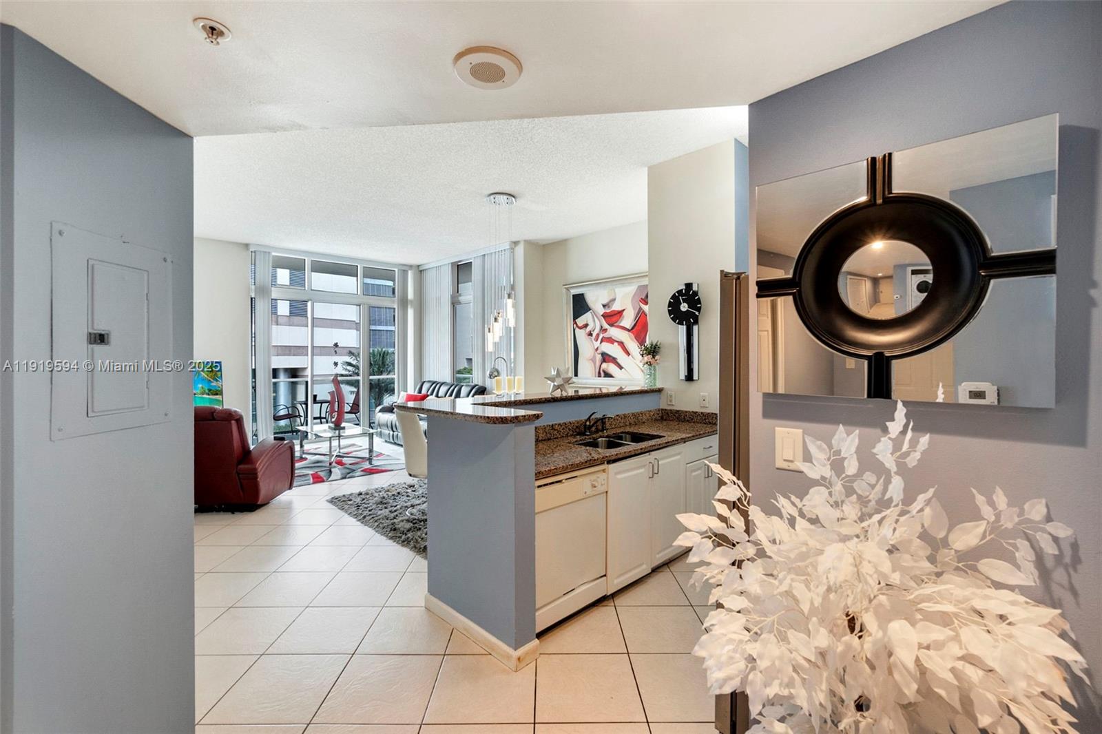 1155 Brickell Bay Drive, Unit 202 Miami, FL 33131 - Photo 16 of 46 a living room with furniture a clock and white walls