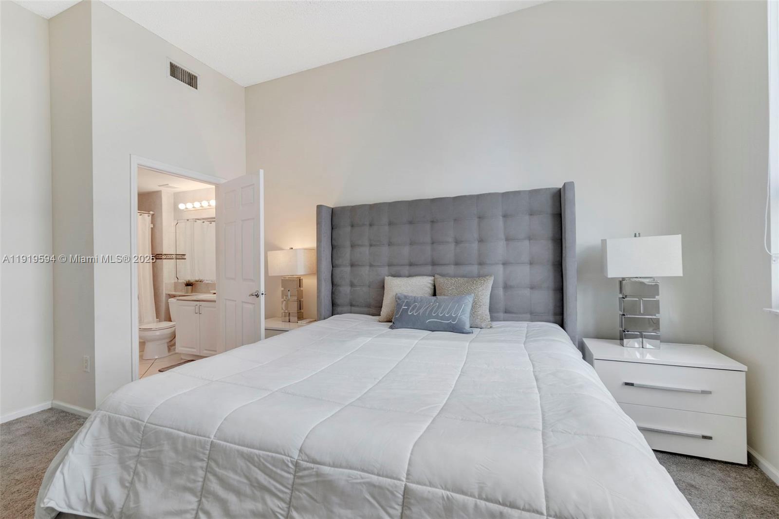 1155 Brickell Bay Drive, Unit 202 Miami, FL 33131 - Photo 21 of 46 a bedroom with a bed and a couch