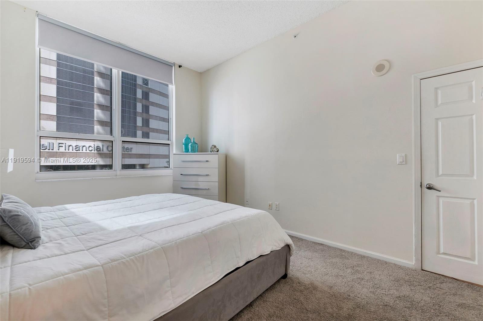 1155 Brickell Bay Drive, Unit 202 Miami, FL 33131 - Photo 22 of 46 a bedroom with a bed and a window