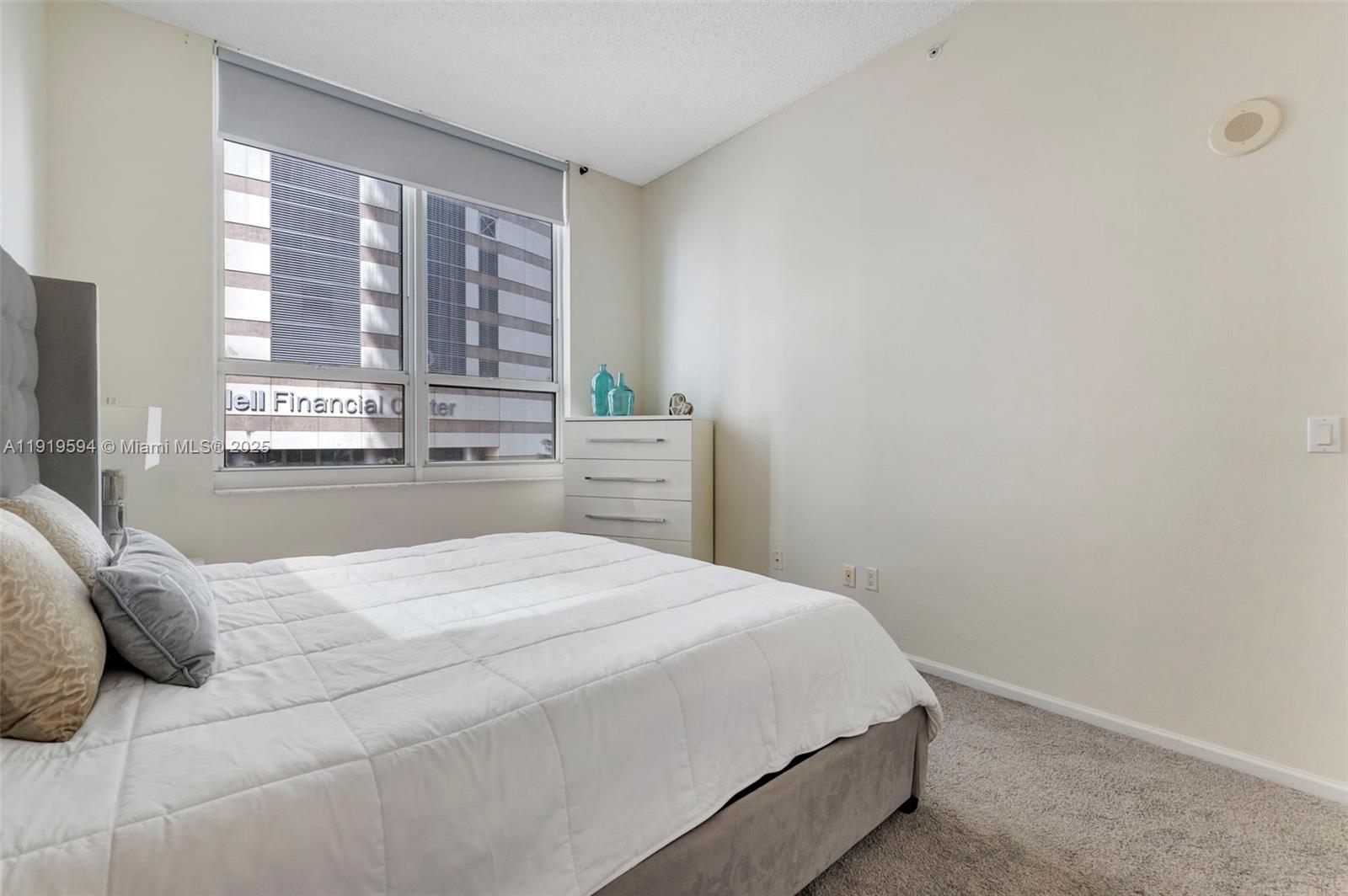 1155 Brickell Bay Drive, Unit 202 Miami, FL 33131 - Photo 23 of 46 a bedroom with a bed and a large window