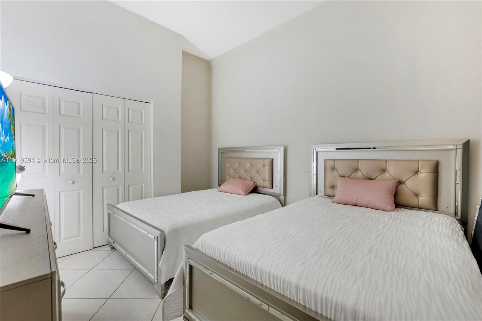 1155 Brickell Bay Drive, Unit 202 Miami, FL 33131 - Photo 26 of 46 a bedroom with two beds and painted walls
