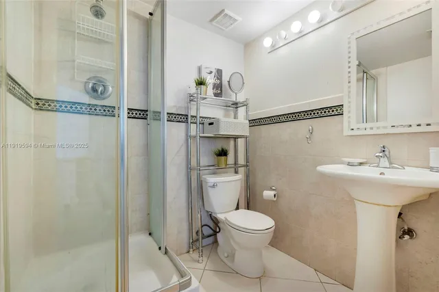 a bathroom with a toilet sink and shower