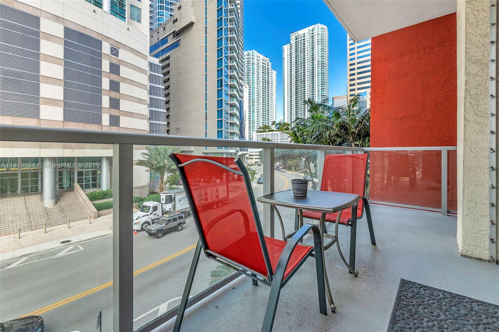 1155 Brickell Bay Drive, Unit 202 Miami, FL 33131 - Photo 29 of 46 a patio with a table and chairs