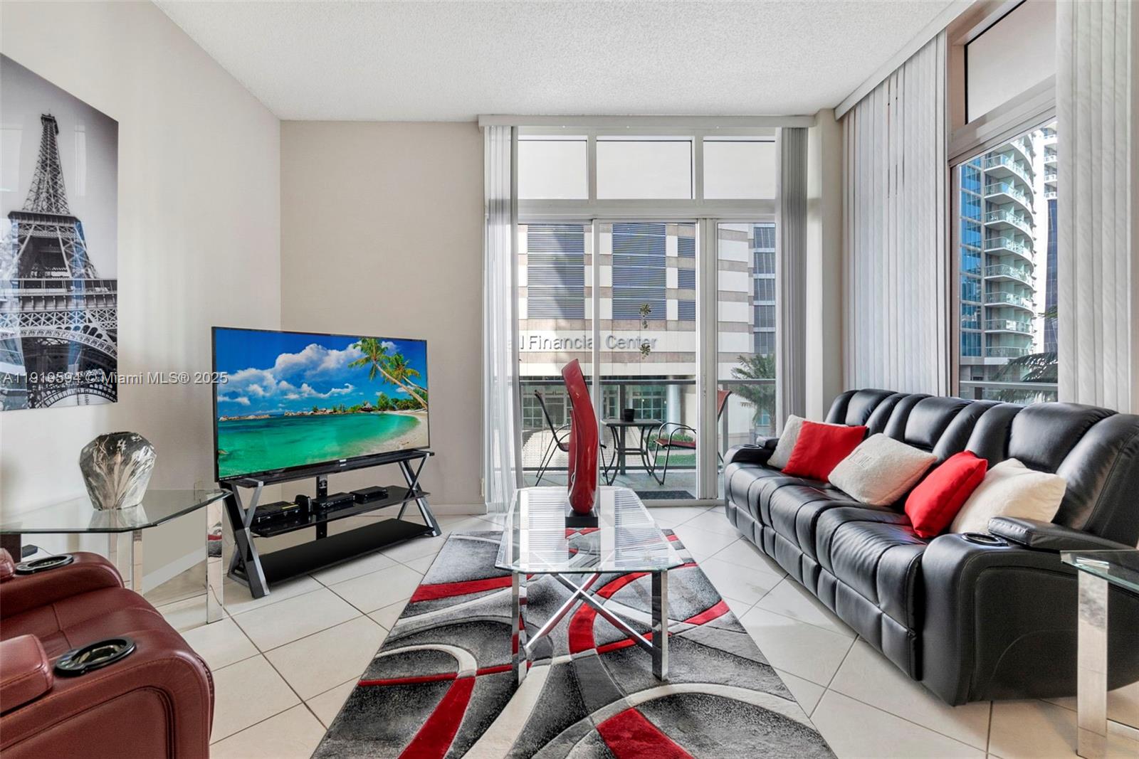 1155 Brickell Bay Drive, Unit 202 Miami, FL 33131 - Photo 8 of 46 a living room with furniture and a flat screen tv