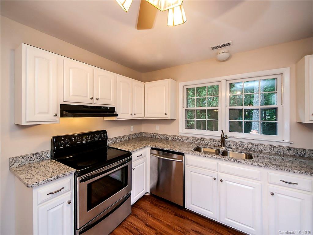 701 Neill Ridge Road Matthews, NC 28105 - Photo 14 of 21 a kitchen with granite countertop a stove sink and cabinets