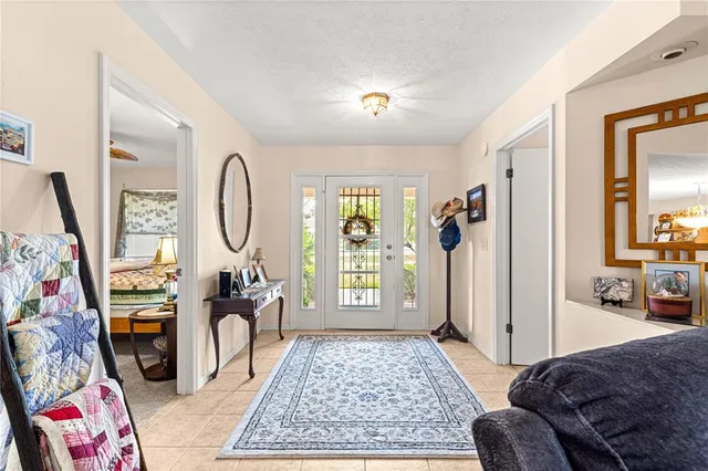 a living room with furniture a rug a flat screen tv and a window