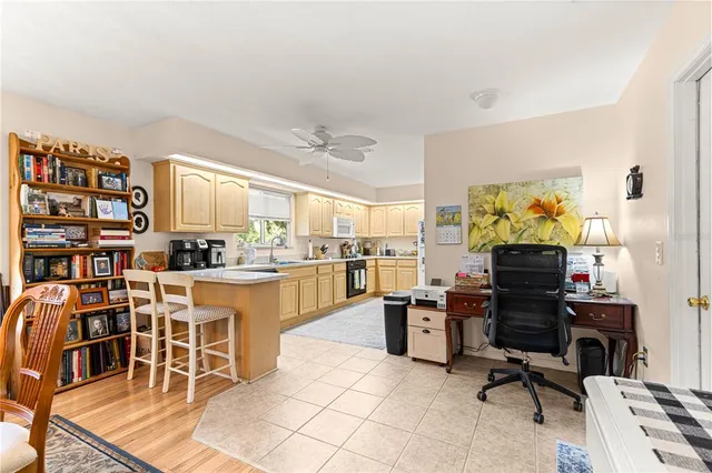 a kitchen with stainless steel appliances kitchen island granite countertop a stove and a refrigerator