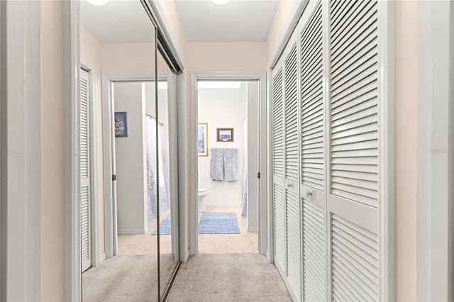a bathroom with a sink a toilet and a large mirror