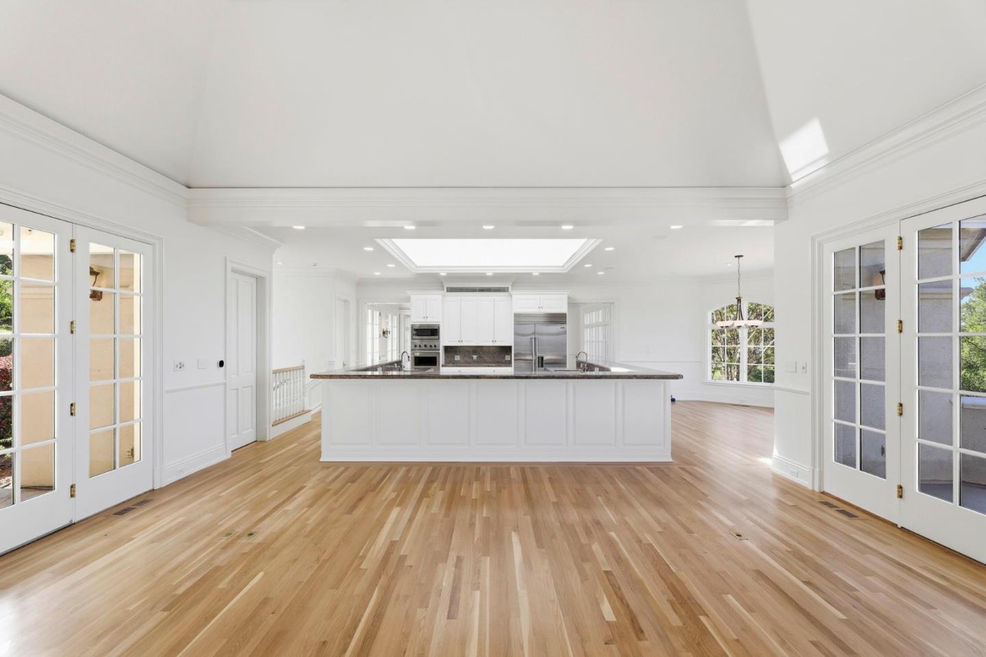 14113 Pike Road Saratoga, CA 95070 - Photo 25 of 78 a large kitchen with kitchen island a large counter top space a sink stainless steel appliances and cabinets