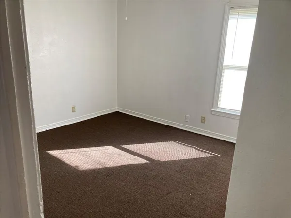 an empty room with wooden floor