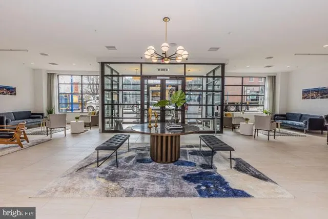 a dining room with furniture and a kitchen view