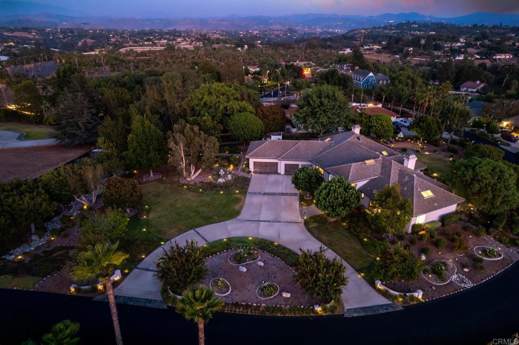 an aerial view of a house with garden space and street view