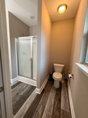 a bathroom with a toilet and a shower