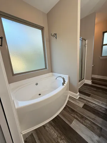 a bathroom with bathtub and shower