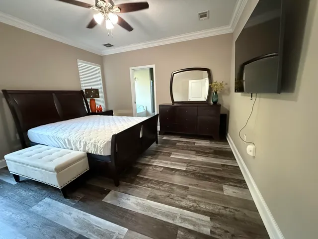 a bedroom with furniture and wooden floor