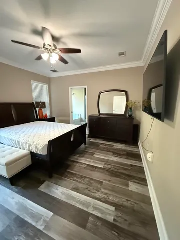 a bedroom with a large bed and a flat screen tv