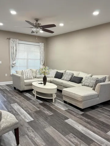a living room with furniture and a large window