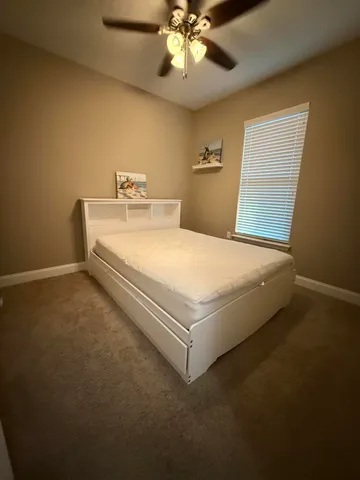 a bed sitting in a room next to a window