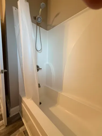 a bathroom with a glass shower door