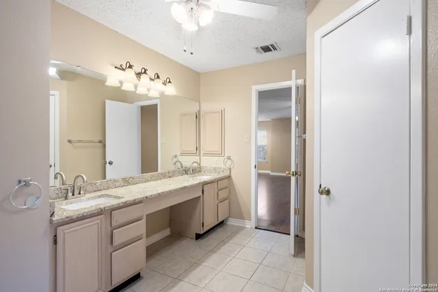a bathroom with a double vanity sink and a mirror