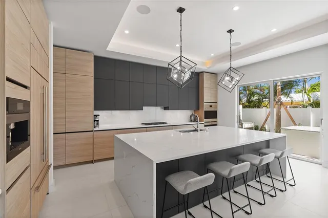 a living room with furniture and kitchen view
