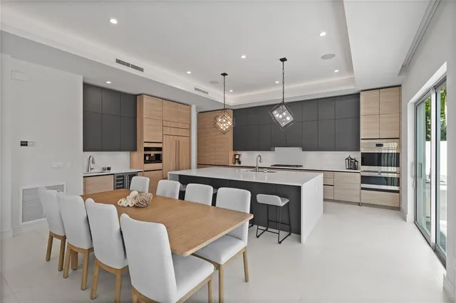 a living room with patio furniture and a floor to ceiling window