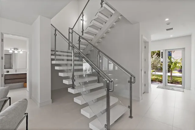 a bedroom with a bed and painting on the wall