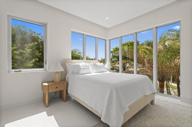 a bedroom with a large bed and a window