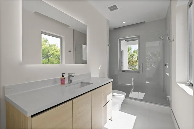 a bathroom with a shower and a toilet