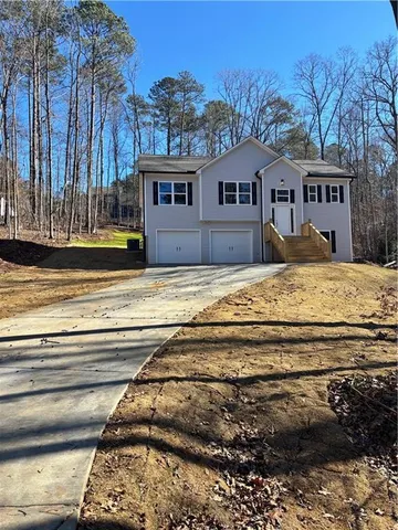 a view of house with backyard and kitchen