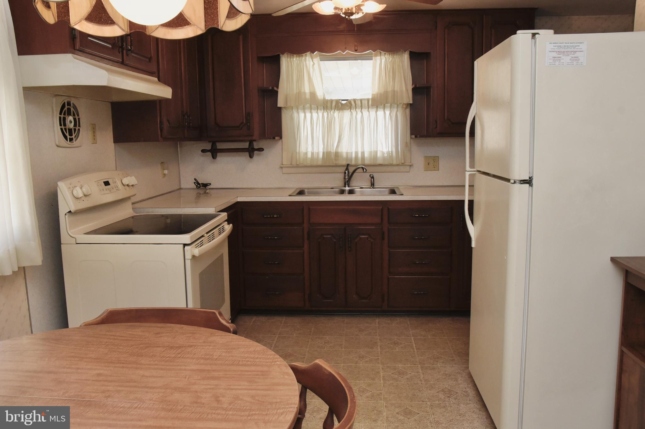 4013 5th Avenue Temple, PA 19560 - Photo 5 of 23 a kitchen with a refrigerator sink and cabinets