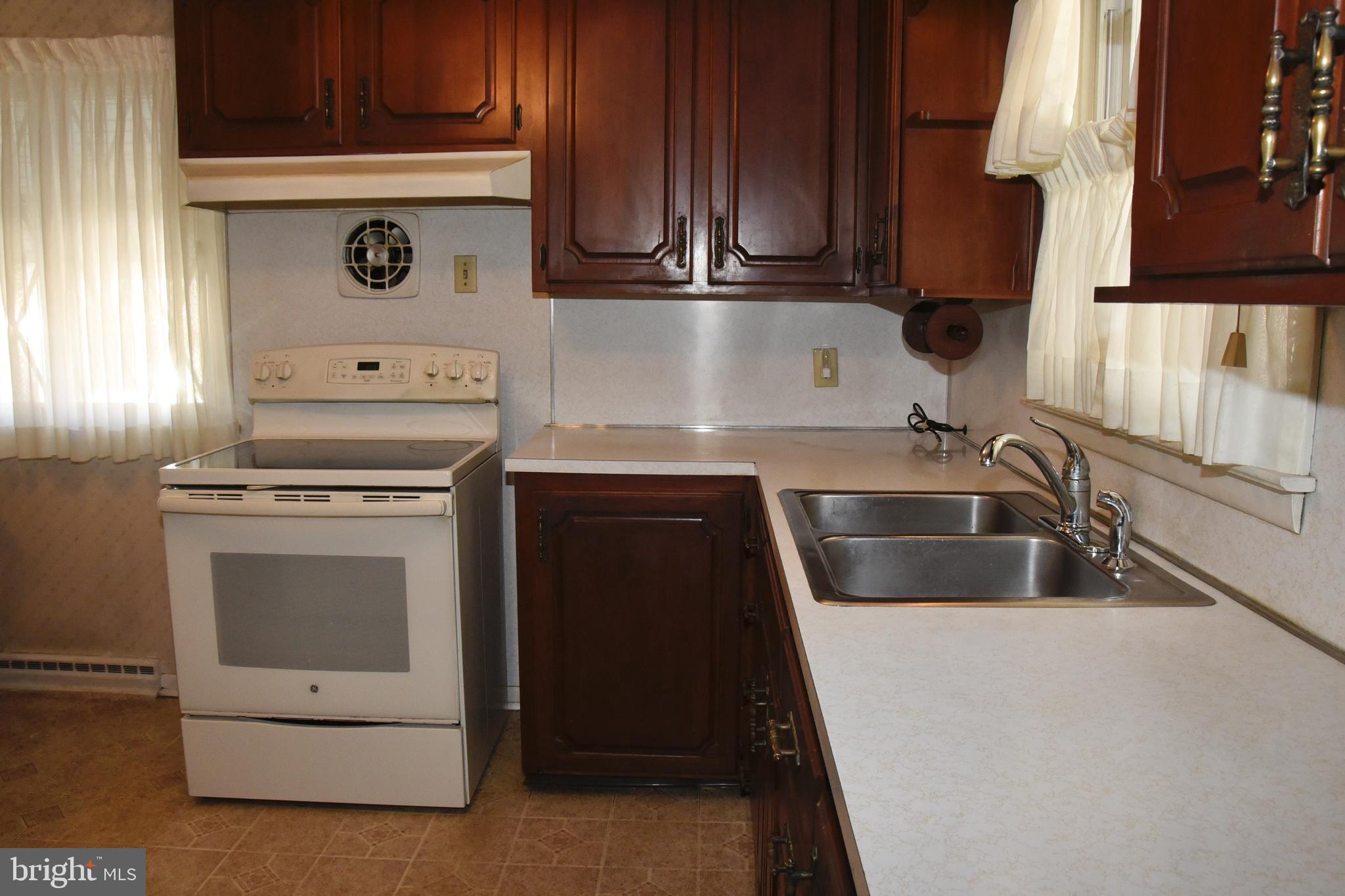 4013 5th Avenue Temple, PA 19560 - Photo 6 of 23 a kitchen with granite countertop a sink stove and cabinets