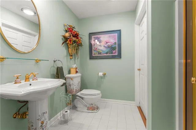 a bathroom with a sink mirror and toilet