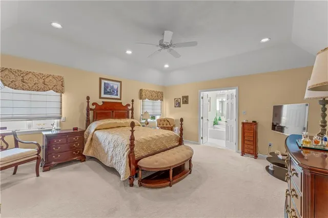 a bedroom with a bed and ceiling fan