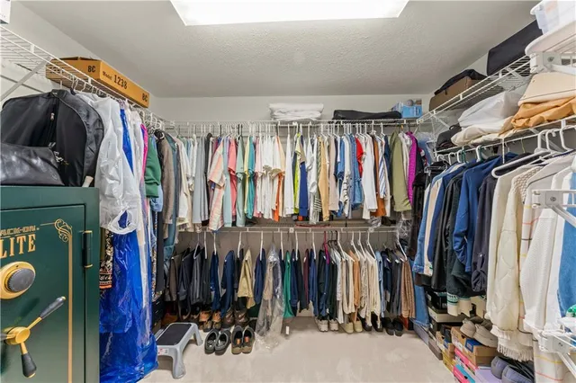 a spacious bathroom with a tub sink and mirror