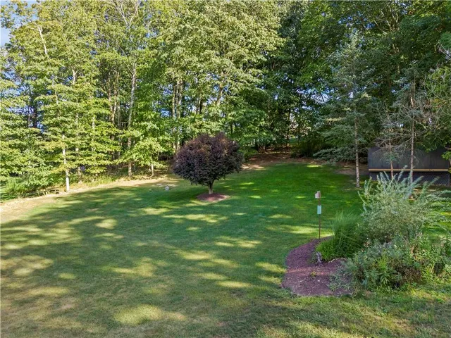 an aerial view of residential houses with outdoor space and trees