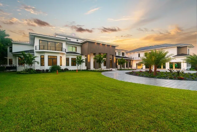 a large white kitchen with granite countertop a large window
